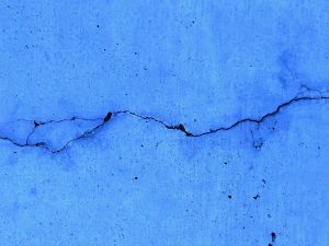 Blue wall with a crack in it
