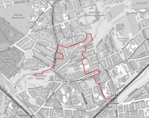 a black and white map of an urban area with a red line