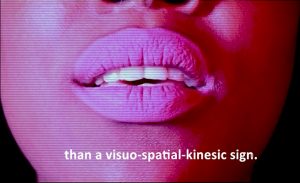 the bottom of a persons face with caption "than a visual spatial kinesic sign."
