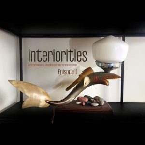 A lamp with a shark base,oon a white background and text that reads "interiorities episode 1"