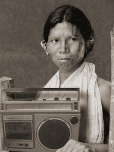A woman holding a large radio