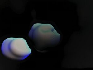 Still from Lara Geary's artwork, a digital sculpture of two lumpy circular shapes on a black background