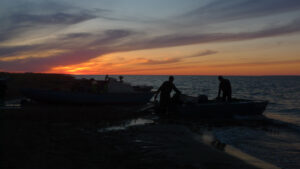 2 people fishing at dusk on the aral sea