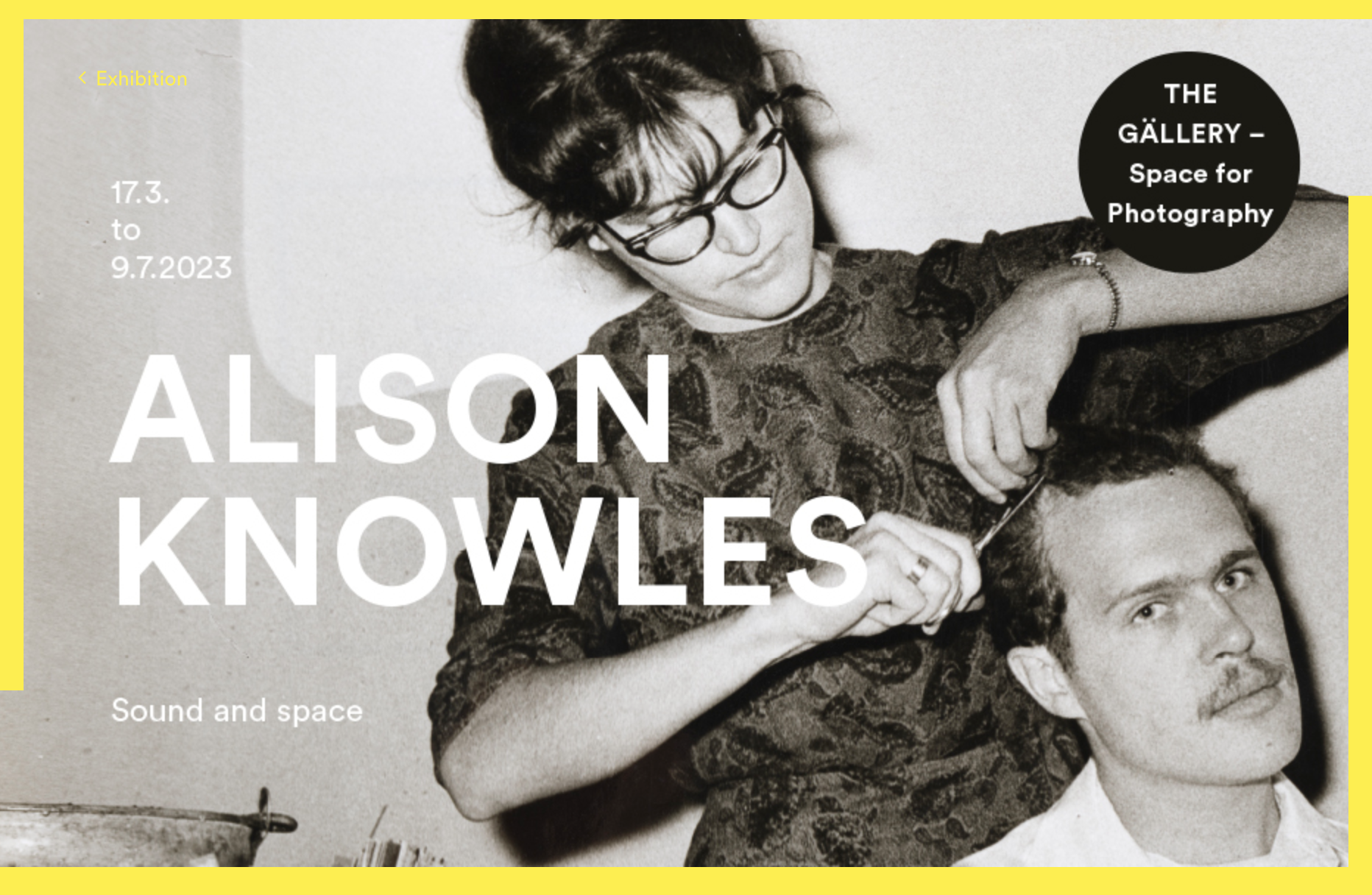 Website screen shot showing the exhibition poster, a black and white picture of Alison cutting a mans hair. exhibition details are overlaid in text
