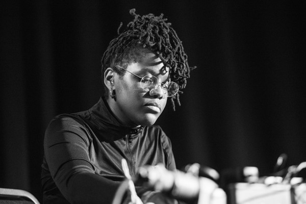 Monochrome image of Shamica Ruddock with out of focus mixing desk in foreground